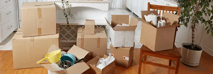 Packed moving boxes and household items in a kitchen before move-out or move-in cleaning, Bloomington, IN.